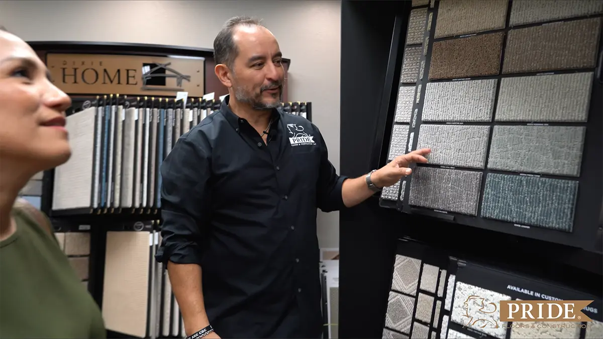 Pride Floors design consultant helping customer select flooring samples in San Antonio showroom