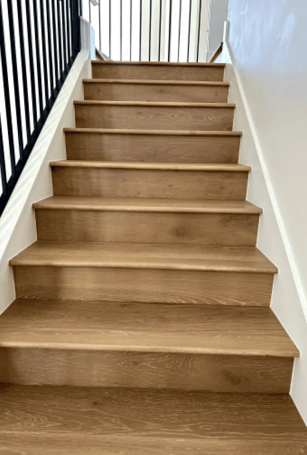 Custom hardwood staircase installation by Pride Floors in San Antonio home