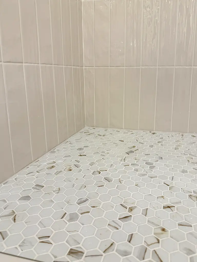 Natural stone hexagon tile flooring installed in San Antonio bathroom shower