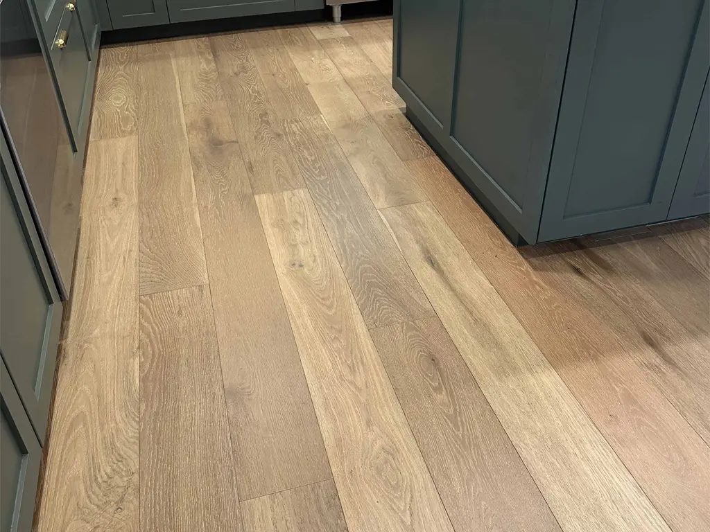 Premium oak hardwood flooring installation in San Antonio kitchen with custom cabinetry