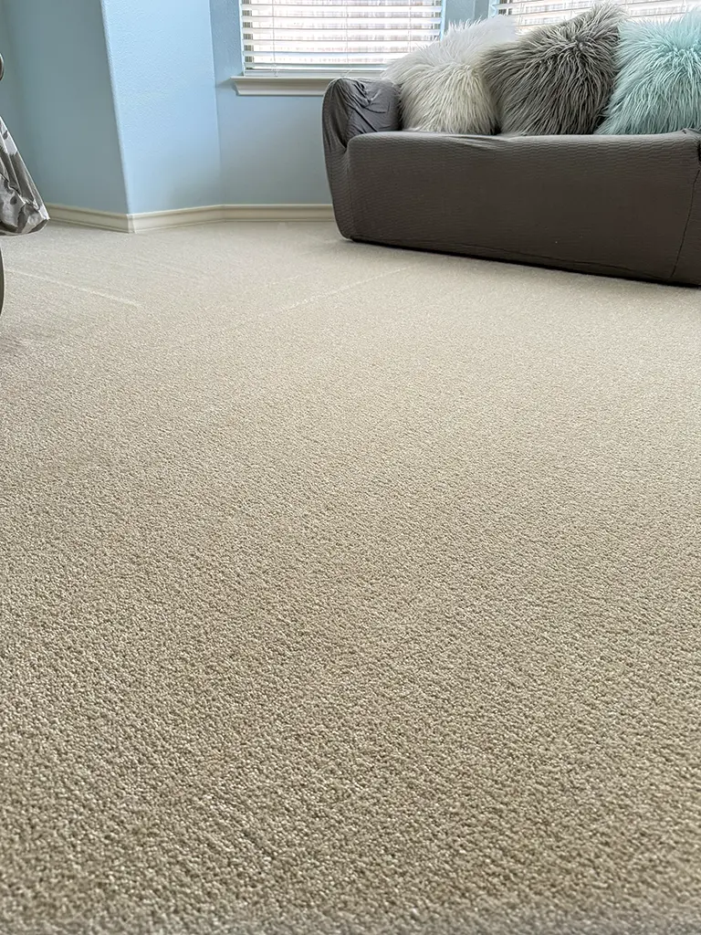 Plush carpet flooring installation in San Antonio bedroom with cozy furniture