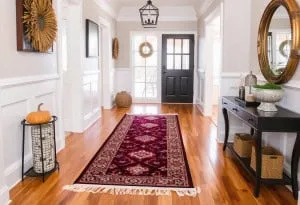 Hallway with area rug on hardwood floors ready for fall in San Antonio