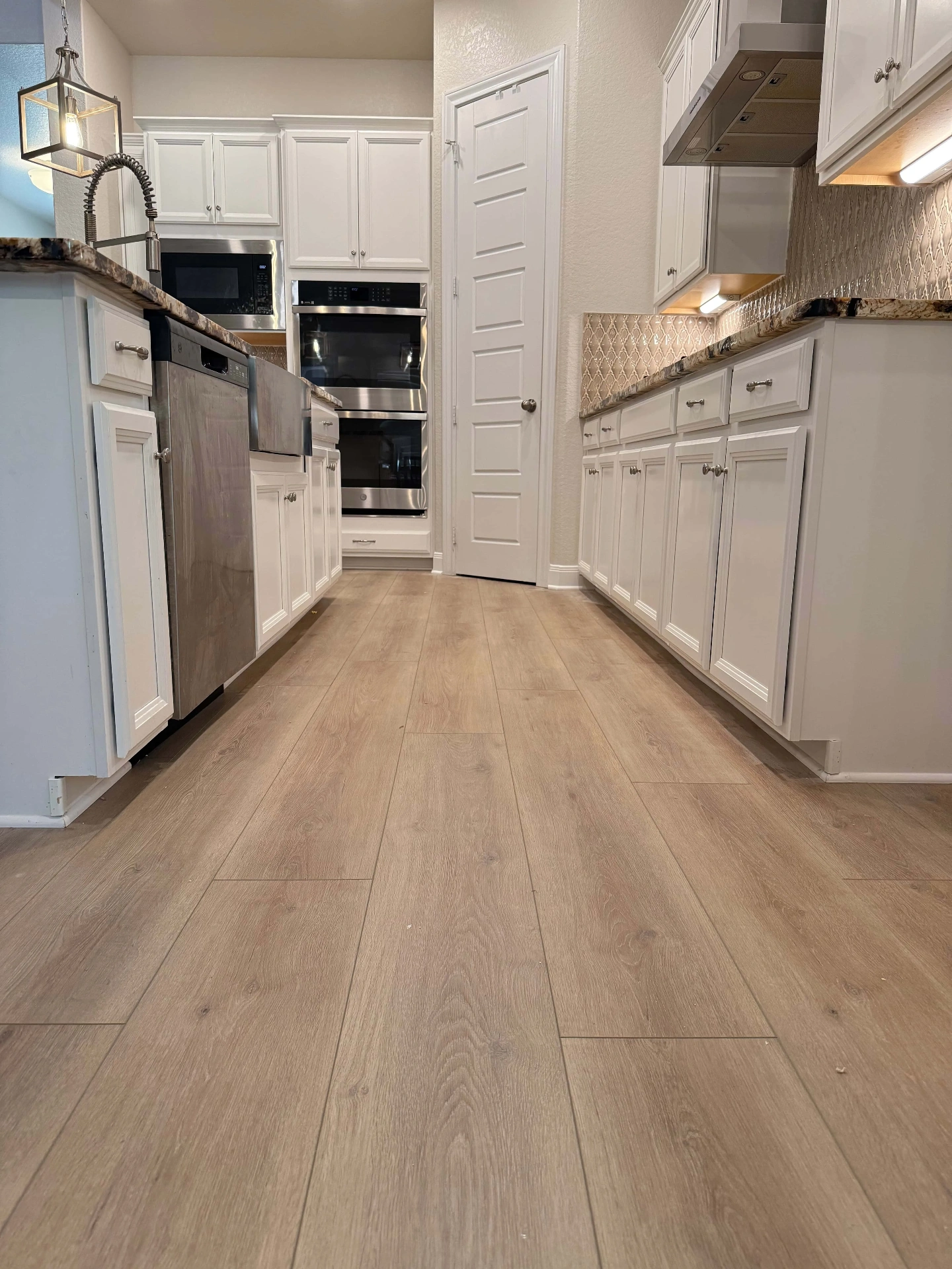 Titan Surfaces Essentials Sandalwood LVP flooring installation in San Antonio, TX by Pride Floors