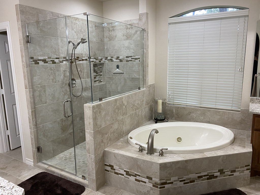 Photo of a remodeled stand in shower and tub with tile.