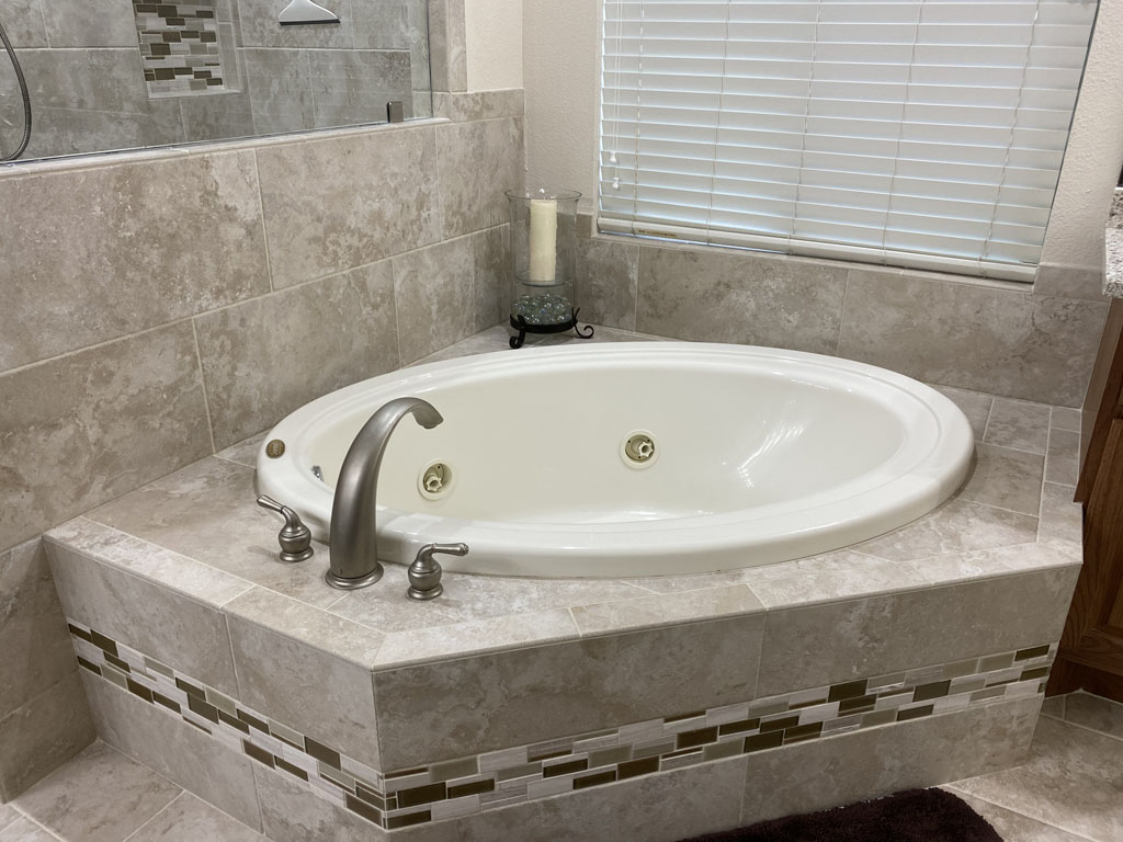 Photo of a remodeled bathroom with new tub and tile.